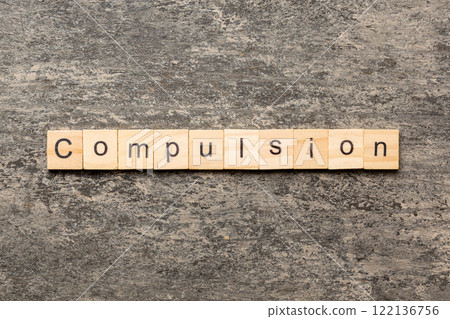 compulsion word written on wood block. compulsion text on table, concept compulsion word written on wood block. compulsion text on table, concept 122136756