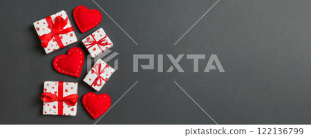 Top view of gift boxes and red textile hearts on colorful background. St Valentine's day concept with copy space Top view of gift boxes and red textile hearts on colorful background. St Valentine's day concept with copy space 122136799