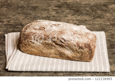 Assortment of freshly baked bread with napkin on rustic table top view. Healthy unleavened bread. French bread 122136905