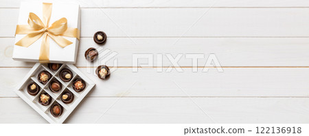 White box with chocolates candies and golden tape. top view with copy space White box with chocolates candies and golden tape. top view with copy space 122136918