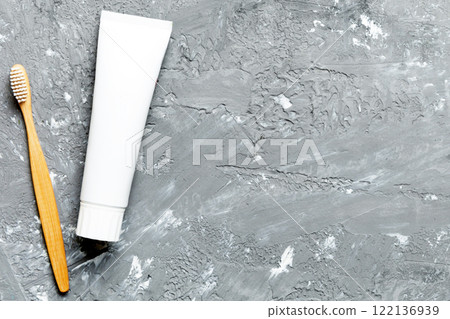 toothpaste and toothbrush top view with copy space on colored background. Flat lay. Dental hygiene. Oral care products on light background. Body care concept 122136939