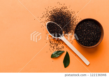 quinoa seeds in bowl and spoon on colored background. Healthy kinwa in small bowl. Healthy superfood quinoa seeds in bowl and spoon on colored background. Healthy kinwa in small bowl. Healthy superfood 122136946