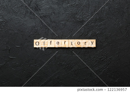 offertory word written on wood block. offertory text on table, concept 122136957