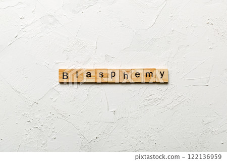 BLASPHEMY word written on wood block. BLASPHEMY text on cement table for your desing, concept BLASPHEMY word written on wood block. BLASPHEMY text on cement table for your desing, concept 122136959