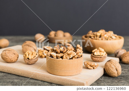 Fresh healthy walnuts in bowl on colored table background. Top view Healthy eating bertholletia concept. Super foods Fresh healthy walnuts in bowl on colored table background. Top view Healthy eating bertholletia concept. Super foods 122136960