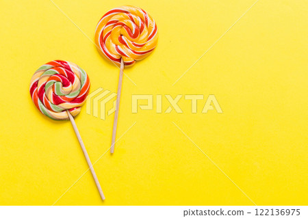 Set of colorful lollipops on colored background. Summer concept. Party Happy Birthday or Minimalist Concept Set of colorful lollipops on colored background. Summer concept. Party Happy Birthday or Minimalist Concept 122136975