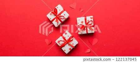 Valentine day composition Background: red gift box with bow and heart. Christmas present. View from above. Holday greeting card 122137045