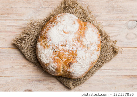 Fresh homemade crisp round bread on napkin, top view. Healthy unleavened bread. French bread. Top view Bakery products Fresh homemade crisp round bread on napkin, top view. Healthy unleavened bread. French bread. Top view Bakery products 122137056