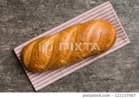 freshly baked bread with napkin on rustic table top view. Healthy white bread loaf isolated freshly baked bread with napkin on rustic table top view. Healthy white bread loaf isolated 122137067