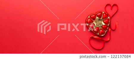 Delicious chocolate pralines in red box for Valentine's Day. Heart shaped box of chocolates top view with copy space 122137084