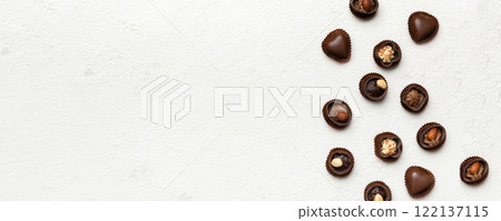 Different kinds of chocolates on colored table close-up. Top View and Flat Lay with copy space Different kinds of chocolates on colored table close-up. Top View and Flat Lay with copy space 122137115