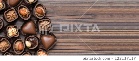 Different kinds of chocolates on colored table close-up. Top View and Flat Lay with copy space Different kinds of chocolates on colored table close-up. Top View and Flat Lay with copy space 122137117