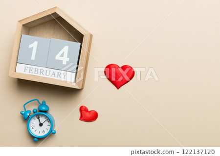 Valentine Day theme with wooden block calendar. Greeting card template for Valentines Day. Top view, copy space for text Valentine Day theme with wooden block calendar. Greeting card template for Valentines Day. Top view, copy space for text 122137120