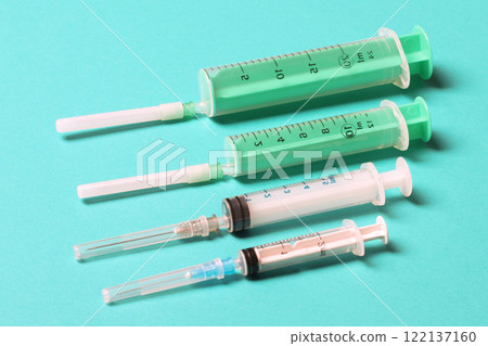 Top view of medical syringes on colorful background with copy space. Injection equipment concept 122137160
