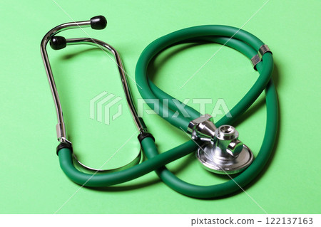 Top view of green stethoscope on colorful background. Medical diagnosis tool concept 122137163