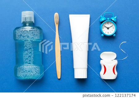 Mouthwash and other oral hygiene products on colored table top view with copy space. Flat lay. Dental hygiene. Oral care products and space for text on light background. concept 122137174