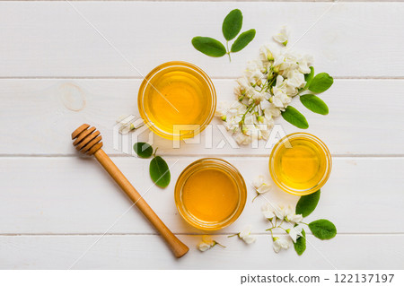 honey jar with acacia flowers and leaves. fresh honey top view flat lay 122137197