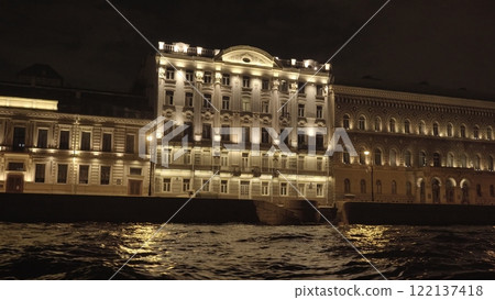 Historic moyka river buildings glowing at night, architectural details reflecting on water's surface in enchanting st. Petersburg evening cityscape Historic moyka river buildings glowing at night, architectural details reflecting on water's surface in enchanting st. Petersburg evening cityscape 122137418