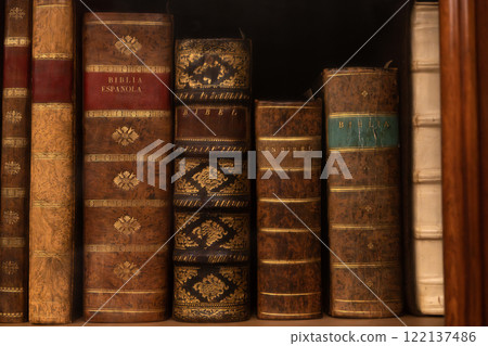 Row of vintage bibles with decorative leather bindings Row of vintage bibles with decorative leather bindings 122137486