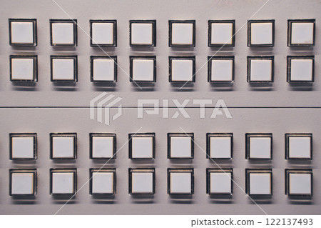 Closeup of white buttons arranged in rows Closeup of white buttons arranged in rows 122137493