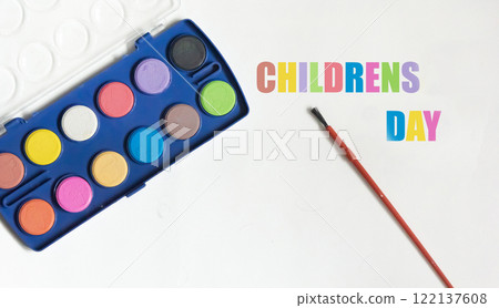 There are multi colored paints on a white background and the inscription CHILDREN'S DAY There are multi colored paints on a white background and the inscription CHILDREN'S DAY 122137608