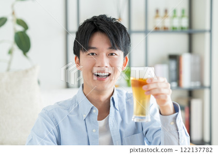 A young man drinking beer A young man drinking beer 122137782