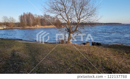 A beautiful spring day at Jugla Lake. A beautiful lake with blue water. 122137788