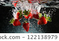 Many strawberries falling into water 122138979