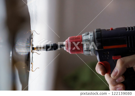 Close-Up of an Electric Drill in Use for Home Improvement Close-Up of an Electric Drill in Use for Home Improvement 122139080