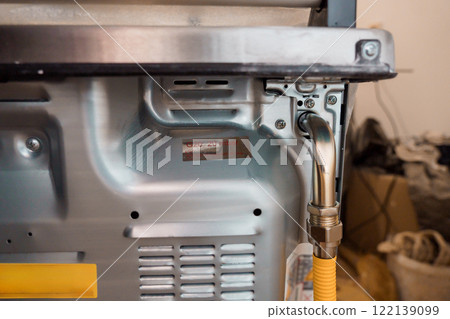 Detailed View of a Gas Connection on a Modern Kitchen Appliance 122139099