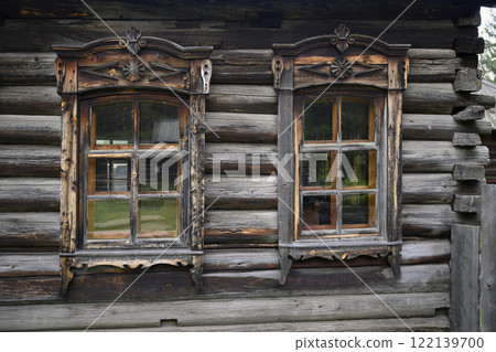 Carved platbands on windows of wooden house built in 1892 in the village of Harety, Siberia, Russia Carved platbands on windows of wooden house built in 1892 in the village of Harety, Siberia, Russia 122139700