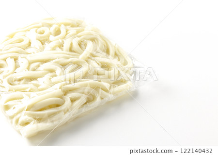 Udon noodles in a bag before boiling, photographed against a white background 122140432