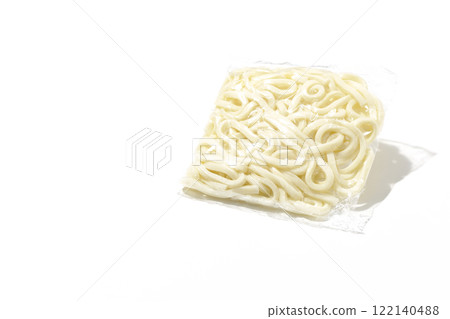 Udon noodles in a bag before boiling, photographed against a white background 122140488