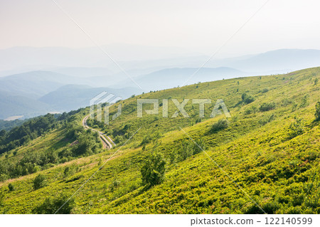 beautiful view of mountain landscape in summer. outdoor adventure. green hill rolling in to the distance in evening light. natural environment of carpathian alps 122140599