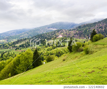 countryside mountain landscape in spring. cloudy weather forecast in may. field and forest on the hill. rolling rural scenery of transcarpathia countryside mountain landscape in spring. cloudy weather forecast in may. field and forest on the hill. rolling rural scenery of transcarpathia 122140602