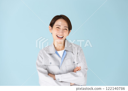 Woman, work clothes, arms crossed Woman, work clothes, arms crossed 122140786