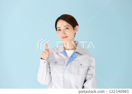 Woman work clothes thumbs up Woman work clothes thumbs up 122140965