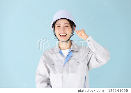 Woman, work clothes, helmet, fist pump Woman, work clothes, helmet, fist pump 122141066