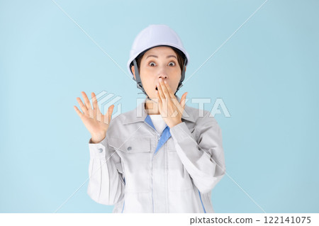 Woman, work clothes, helmet, surprised Woman, work clothes, helmet, surprised 122141075