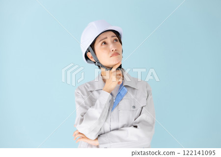 Woman work clothes helmet worries Woman work clothes helmet worries 122141095