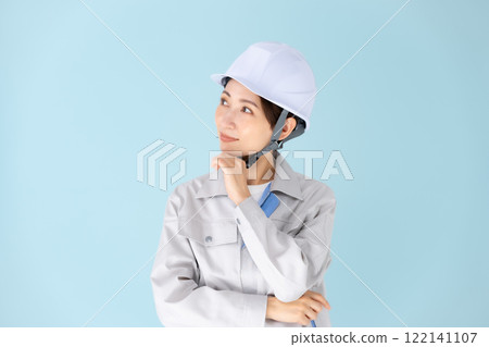 Woman, work clothes, helmet, smiling Woman, work clothes, helmet, smiling 122141107
