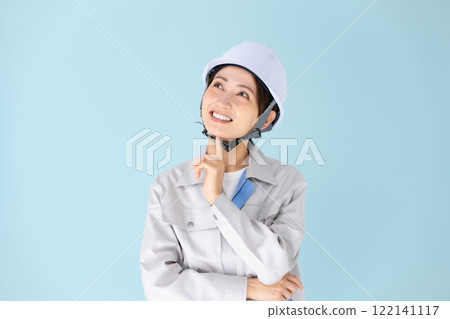 Woman, work clothes, helmet, smiling Woman, work clothes, helmet, smiling 122141117