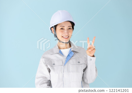 Woman, work clothes, helmet, peace sign 122141201