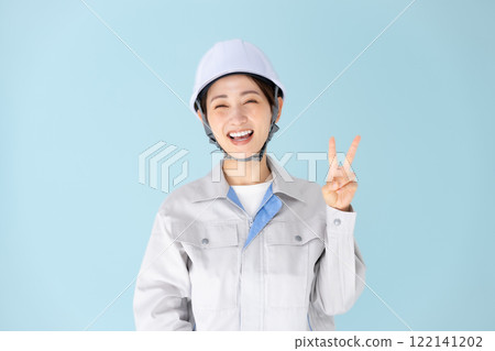 Woman, work clothes, helmet, peace sign 122141202
