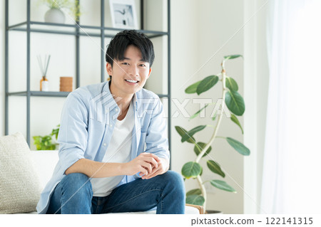 Young man relaxing in the living room 122141315