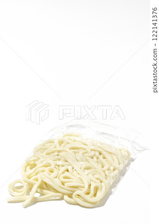 Udon noodles in a bag before boiling, photographed against a white background 122141376