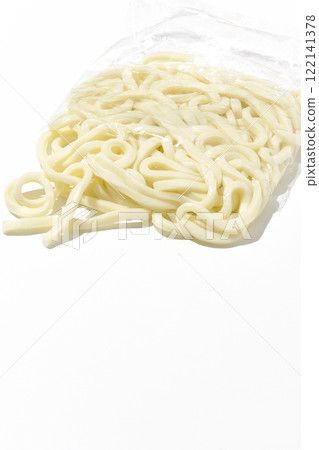 Udon noodles in a bag before boiling, photographed against a white background Udon noodles in a bag before boiling, photographed against a white background 122141378