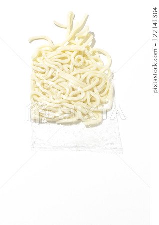 Udon noodles in a bag before boiling, photographed against a white background 122141384