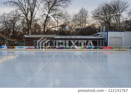 Evening skating rink without people. Weekend evening, people are waiting for the ice to be rubbed on the skating rink. 122141767