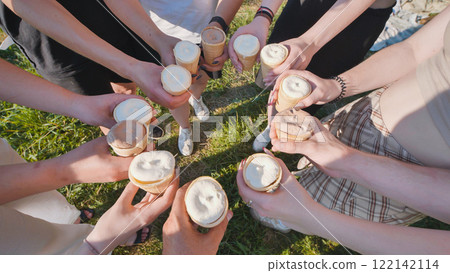 Friends holding ice cream cones in a circle on a sunny day 122142114